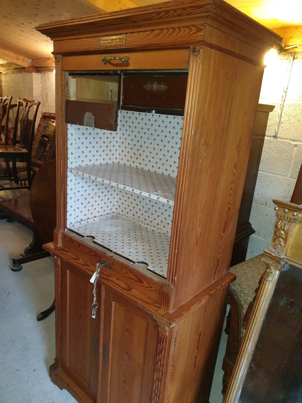 A tall Edwardian pine office cabinet featuring a slatted tambour roll shutter upper section above a two-door panelled lower cupboard. View II