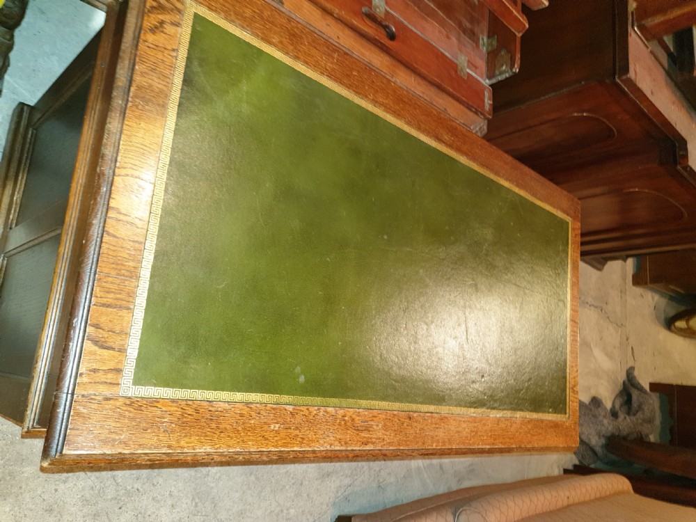 Neat Edwardian oak kneehole pedestal panelled desk.  View II