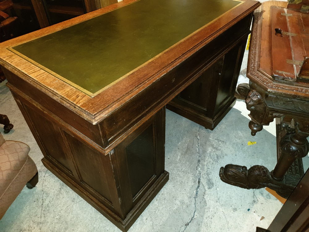 Neat Edwardian oak kneehole pedestal panelled desk.  View IV