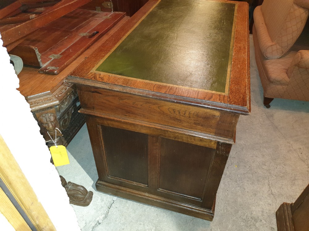 Neat Edwardian oak kneehole pedestal panelled desk.  View V