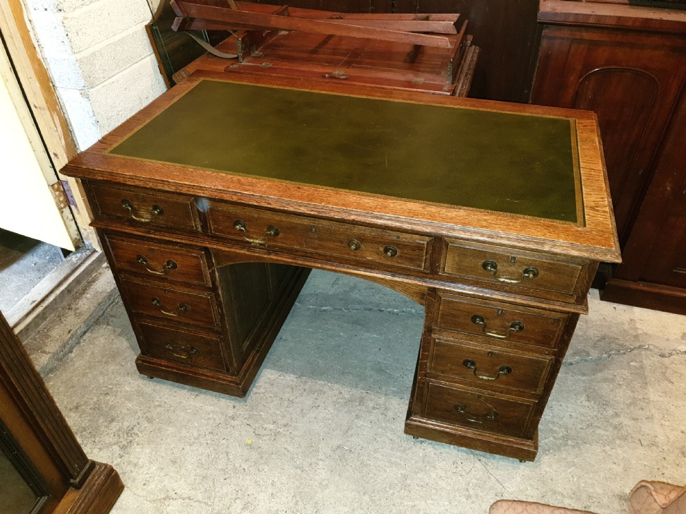 Neat Edwardian oak kneehole pedestal panelled desk.  View VII
