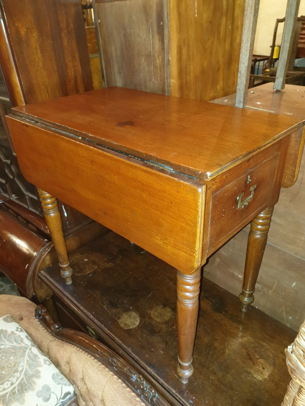 An antique teak ships washstand table featuring a hinged lid opening to reveal circular basin cutouts, resting on turned legs with brass side handles. View II