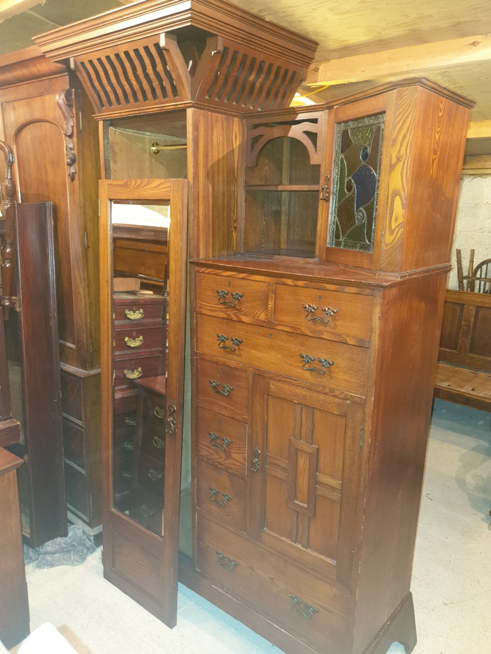 An Arts and Crafts ash bedroom suite featuring a multi-functional compactum wardrobe with leaded glass, a dressing table with mirror, and a tiled washstand with marble surface. View II