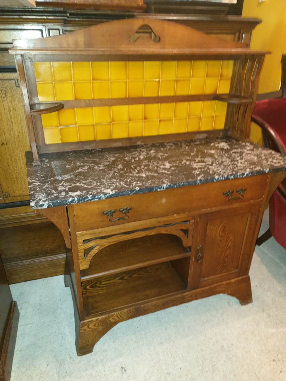 An Arts and Crafts ash bedroom suite featuring a multi-functional compactum wardrobe with leaded glass, a dressing table with mirror, and a tiled washstand with marble surface. View IX