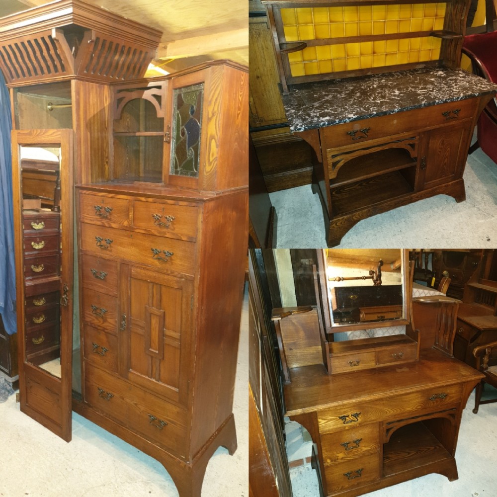 An Arts and Crafts ash bedroom suite featuring a multi-functional compactum wardrobe with leaded glass, a dressing table with mirror, and a tiled washstand with marble surface.