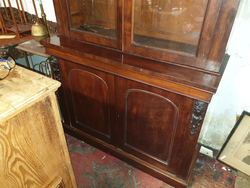 A mid-19th century Victorian mahogany two-part bookcase featuring a glazed upper cabinet with arched glass panes above a lower cupboard base. View III