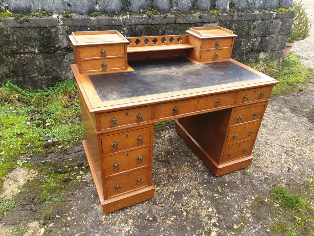 Late Victorian light oak kneehole pedestal desk. 