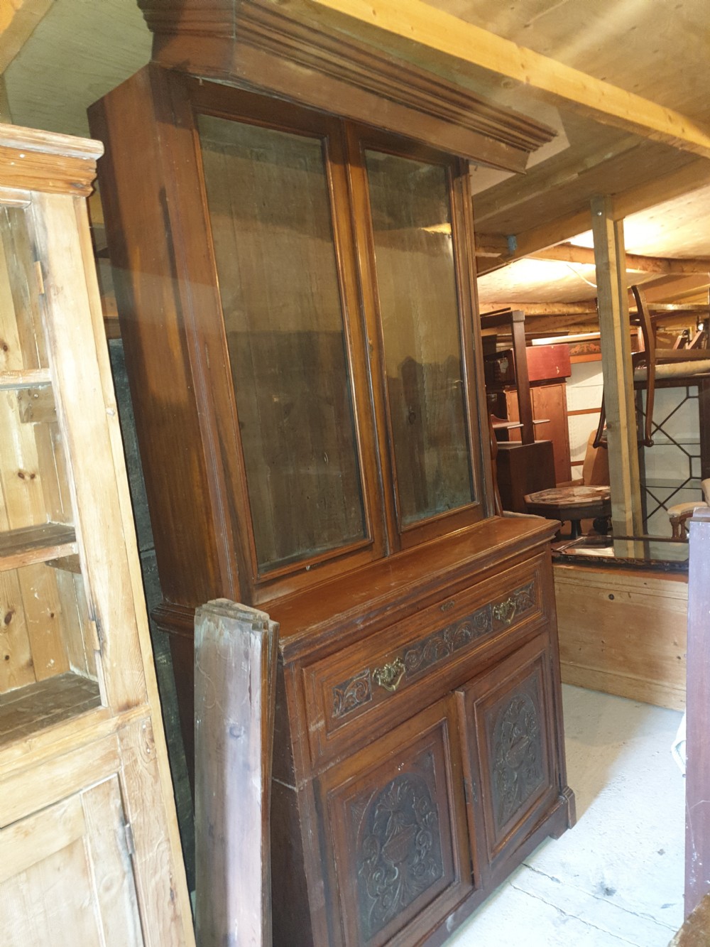 A late Victorian walnut secretaire bookcase featuring double glazed upper doors, a pull-out fitted writing drawer with interior compartments, and carved lower doors. View II