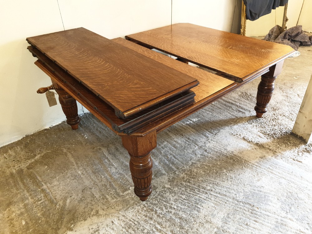 Large Victorian oak extending dining table. 