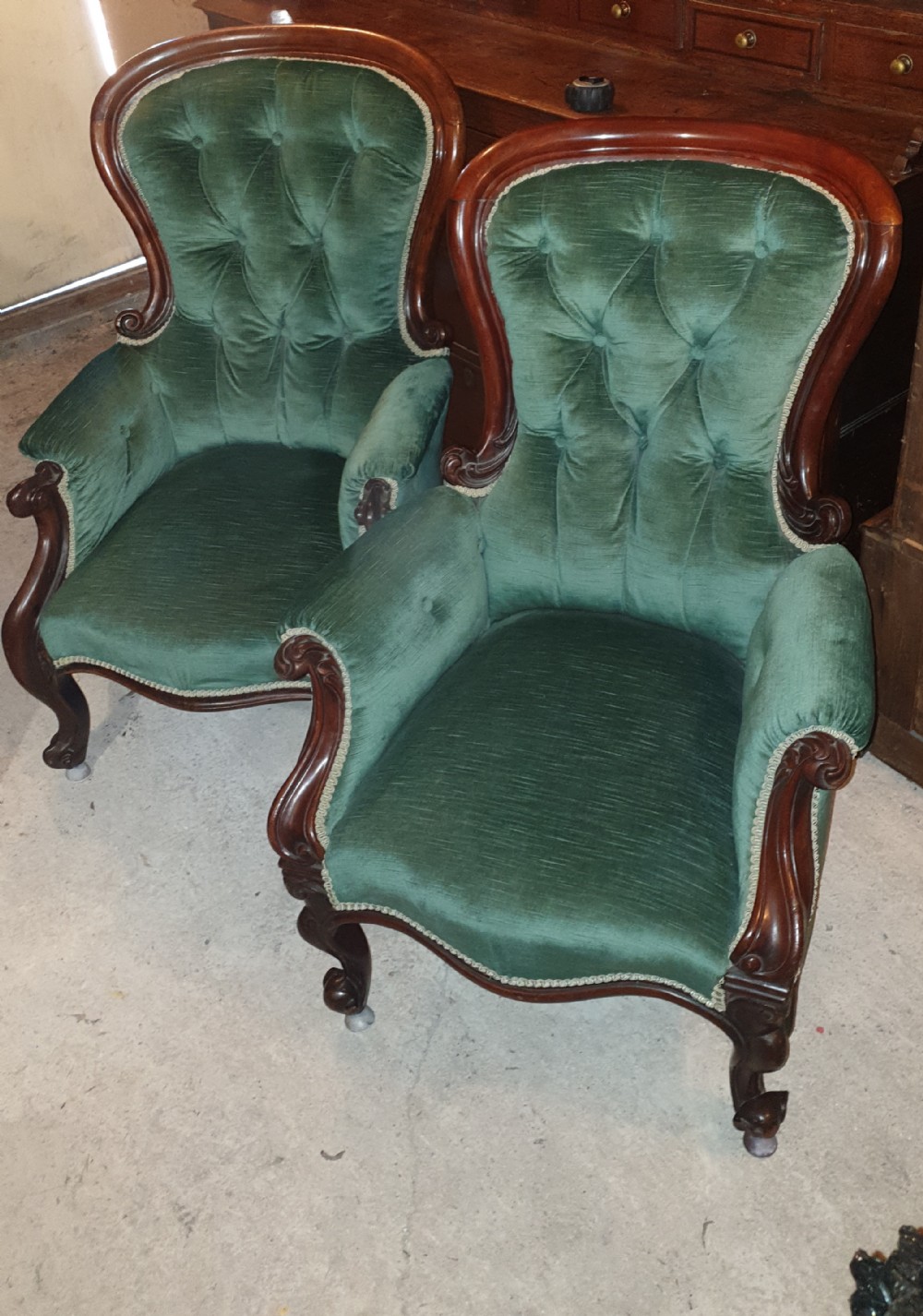 Close pair of Mahogany frame Spoon back upholstered armchairs. 