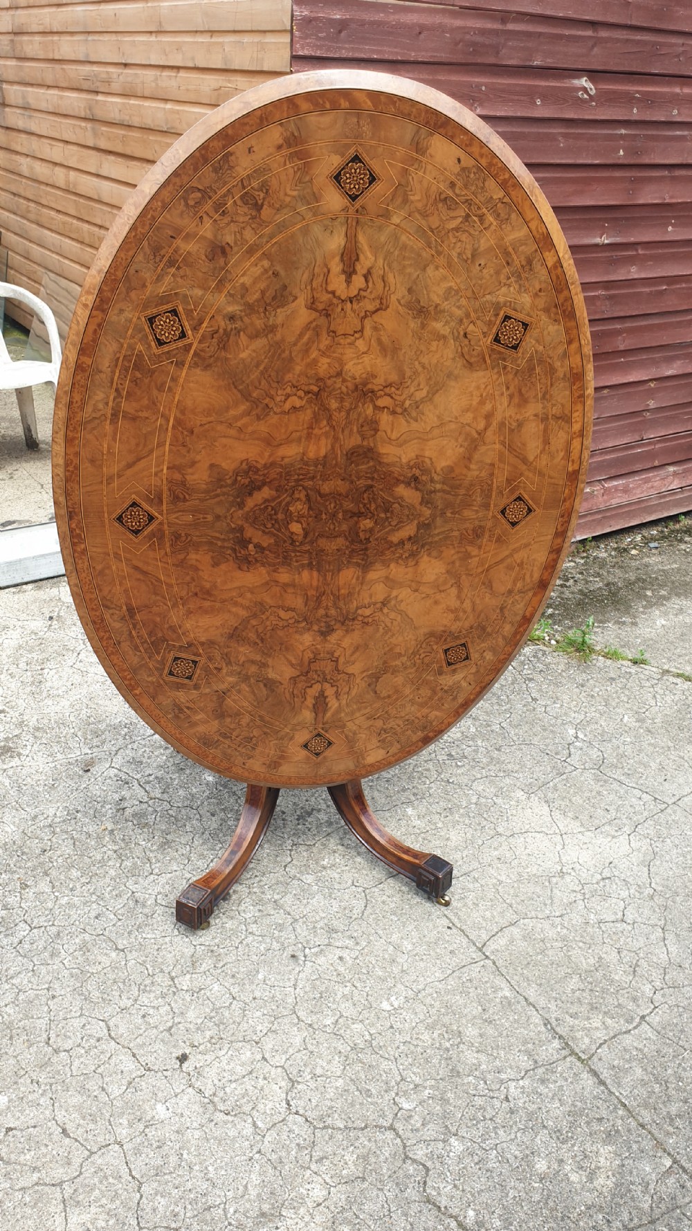 Victorian inlaid walnut oval tip top pedestal table. 