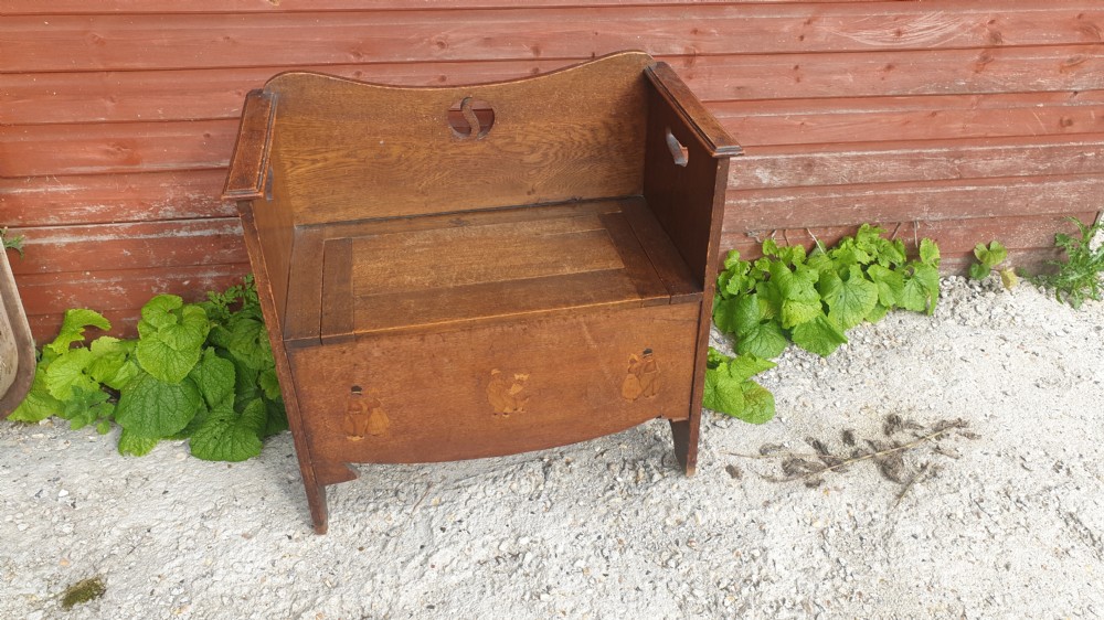Inlaid oak hall seat in the manner of Liberty's. 