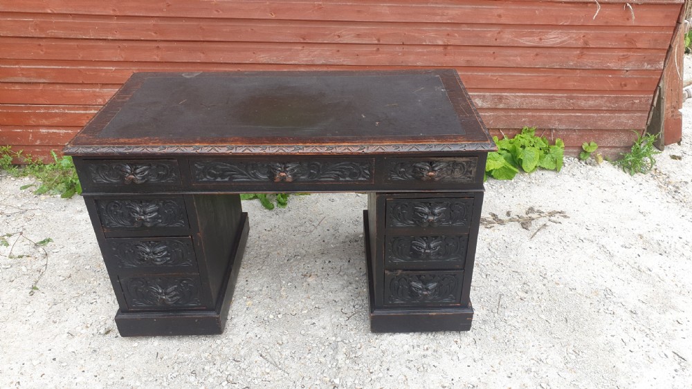 Late Victorian carved oak Green Man pedestal desk. 