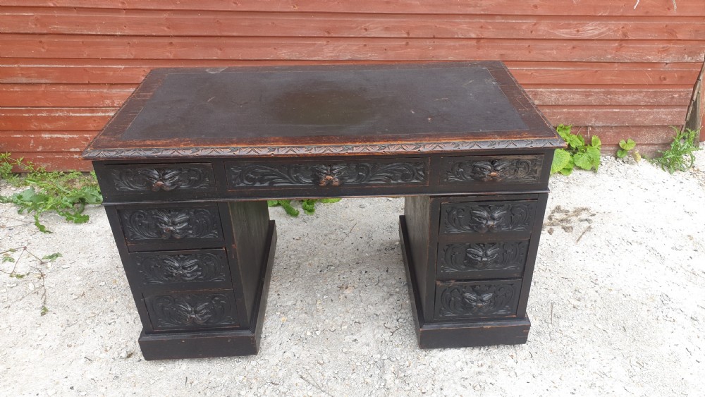 Late Victorian carved oak Green Man pedestal desk.  View IV