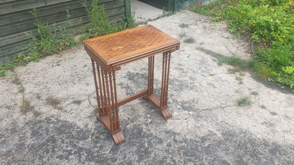 A set of three graduated wooden nesting tables featuring geometric parquetry tops inlaid with delicate floral and bird motifs. View III