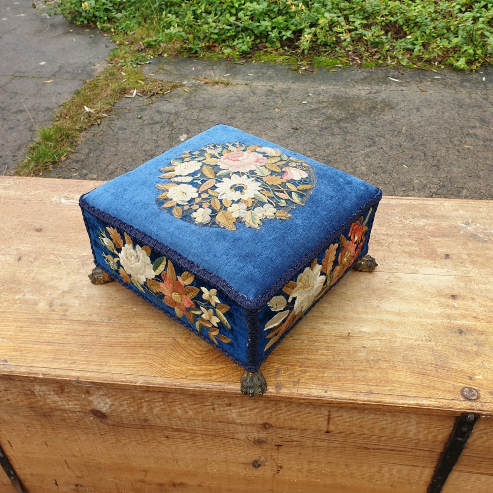 Crewel work foot stool with cast brass feet. View III