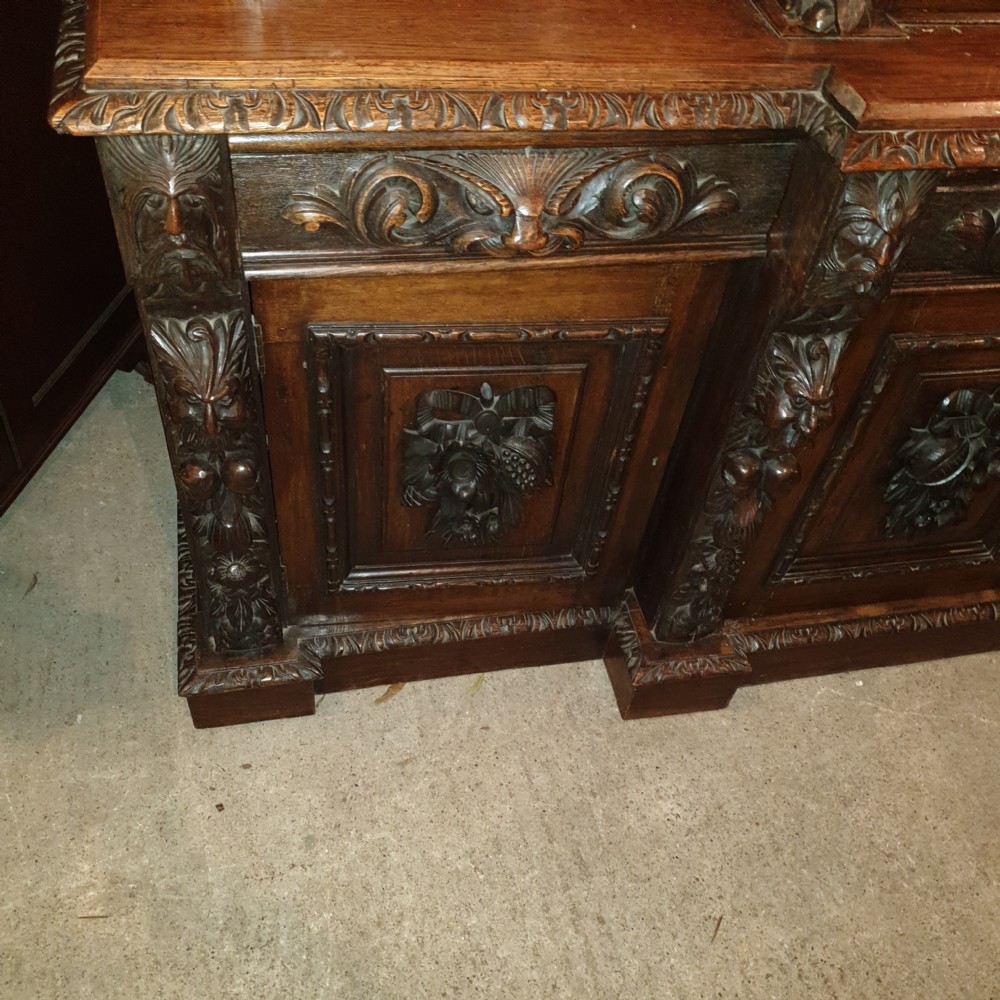 Good Victorian carved oak Green Man breakfront bookcase.  View IV
