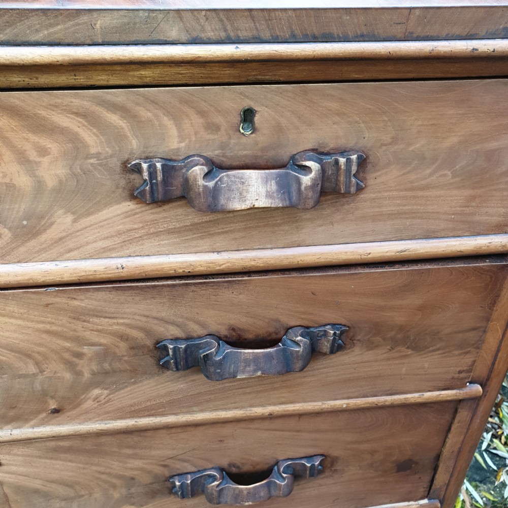 A large Victorian mahogany chest of drawers featuring two short over four long graduated drawers with carved wooden handles and a plinth base. View III