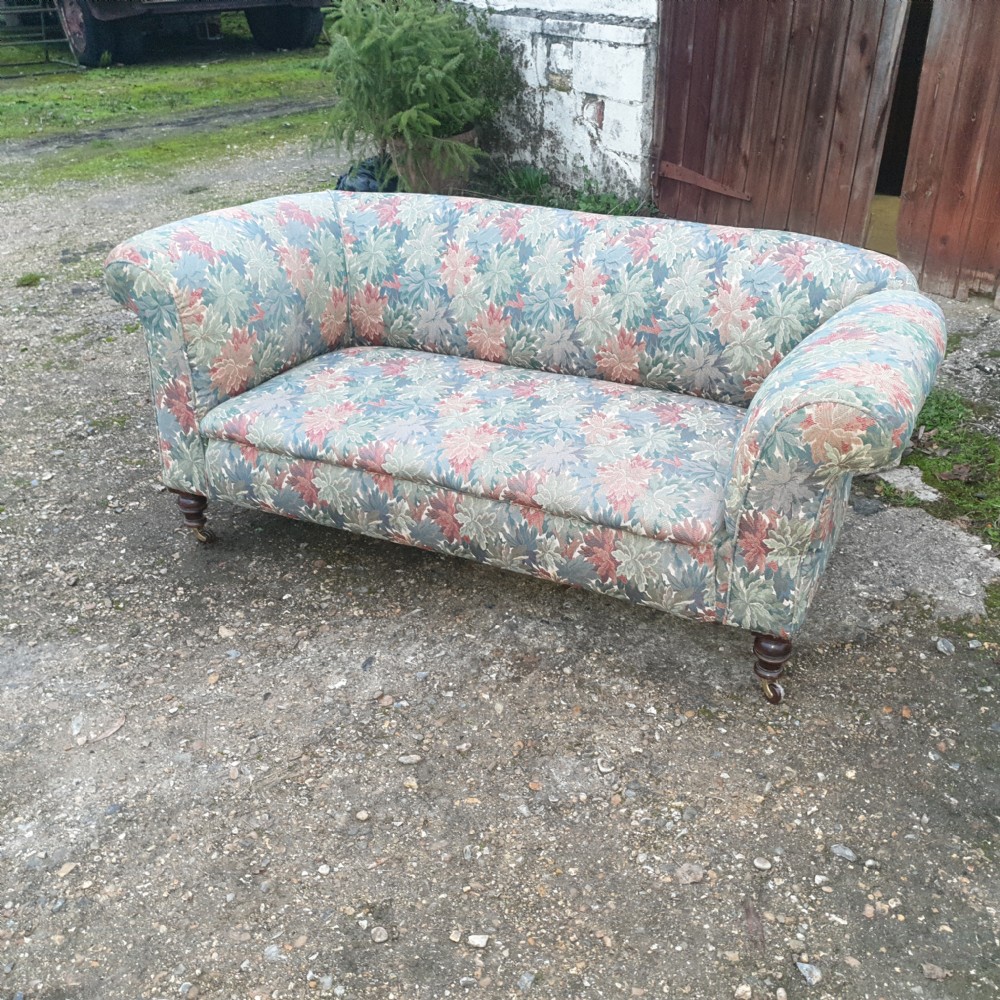 Edwardian upholstered Chesterfield sofa with drop arm. View IX