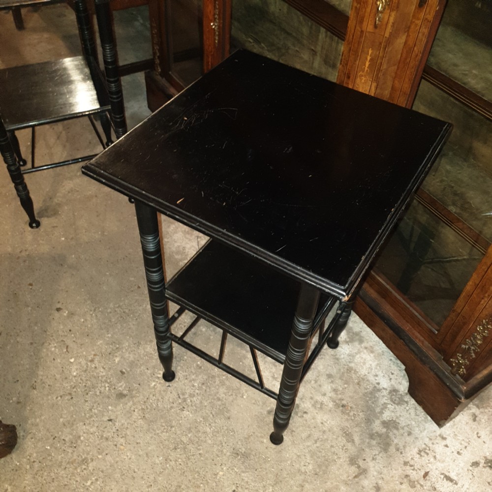 Close pair of ebonised occasional tables in the of E W Godwin.  View II