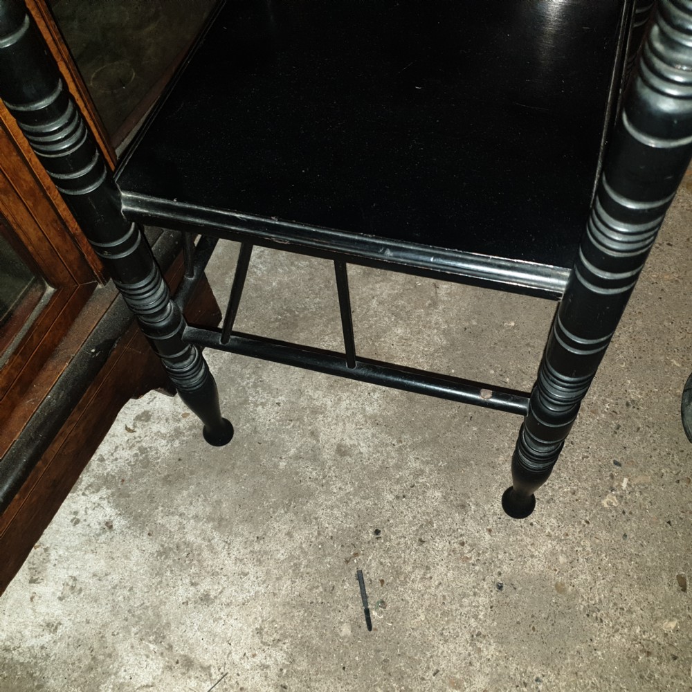 Close pair of ebonised occasional tables in the of E W Godwin.  View IV