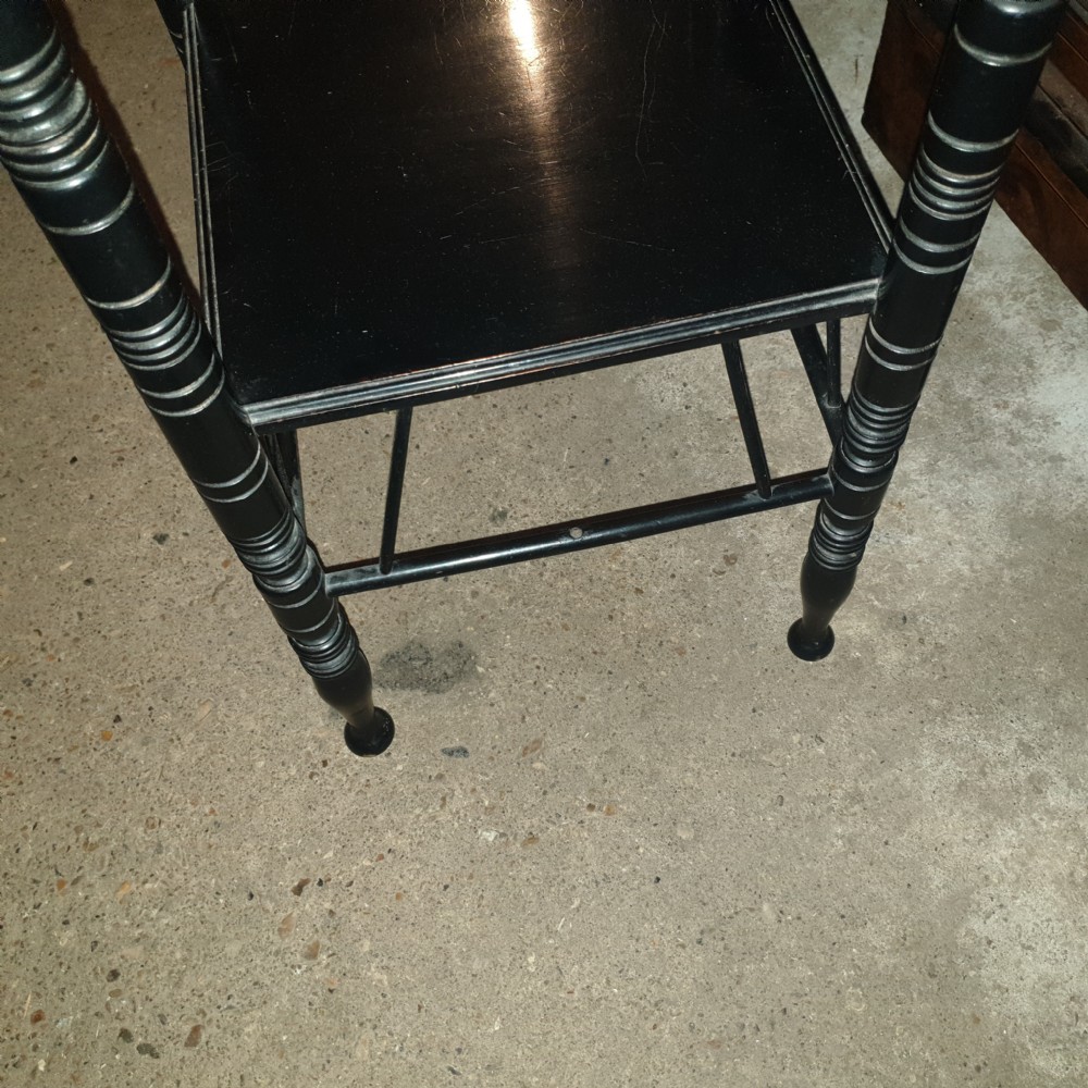 Close pair of ebonised occasional tables in the of E W Godwin.  View V