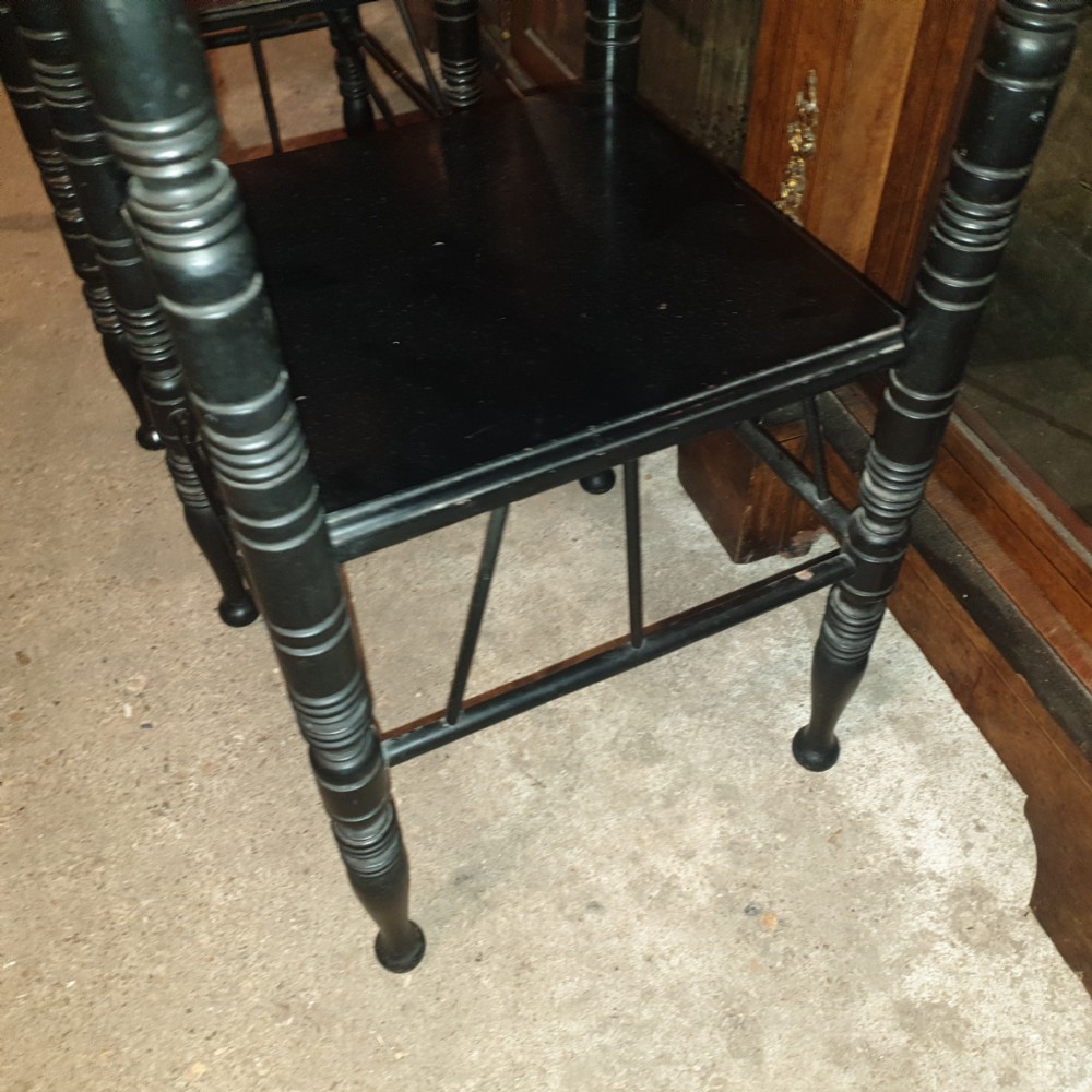 Close pair of ebonised occasional tables in the of E W Godwin.  View VI