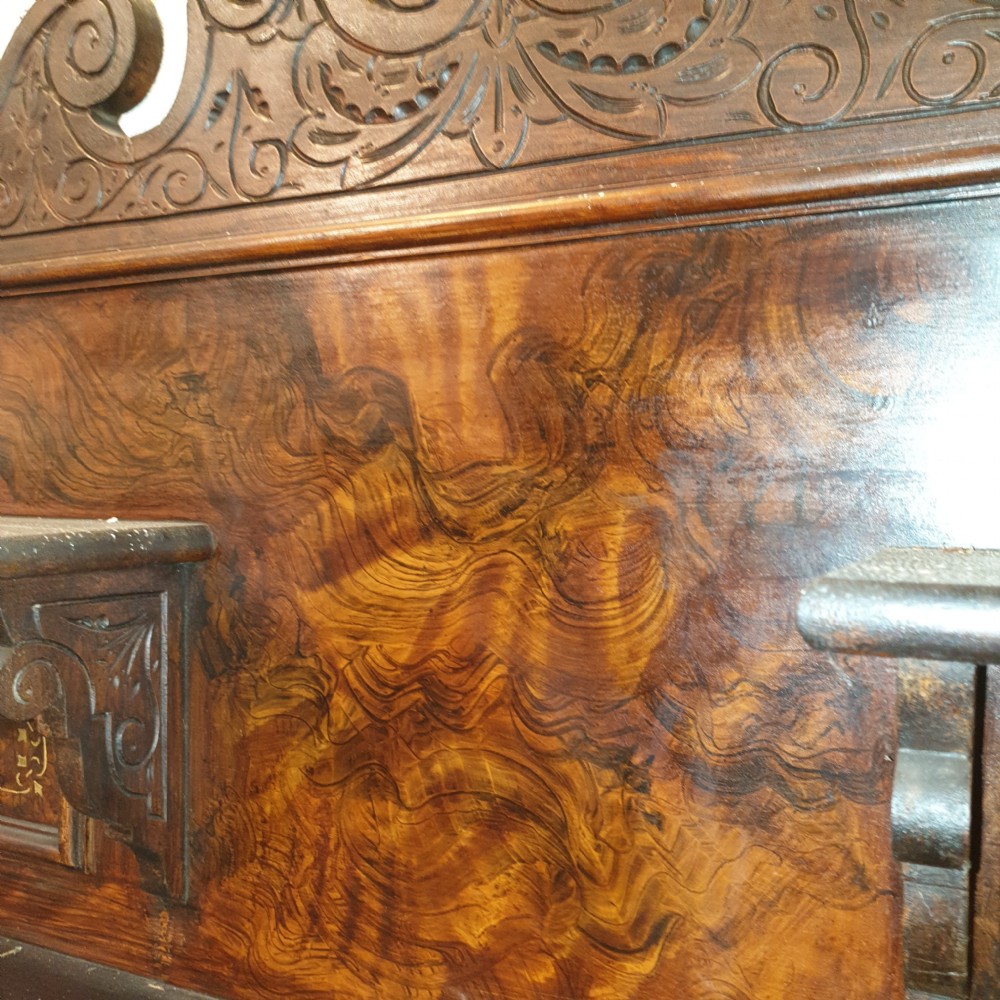 A dark brown Scottish Victorian dresser featuring a carved cresting rail, upper shelves, two drawers, and twin cupboard doors with a scumbled faux-grain finish. View III