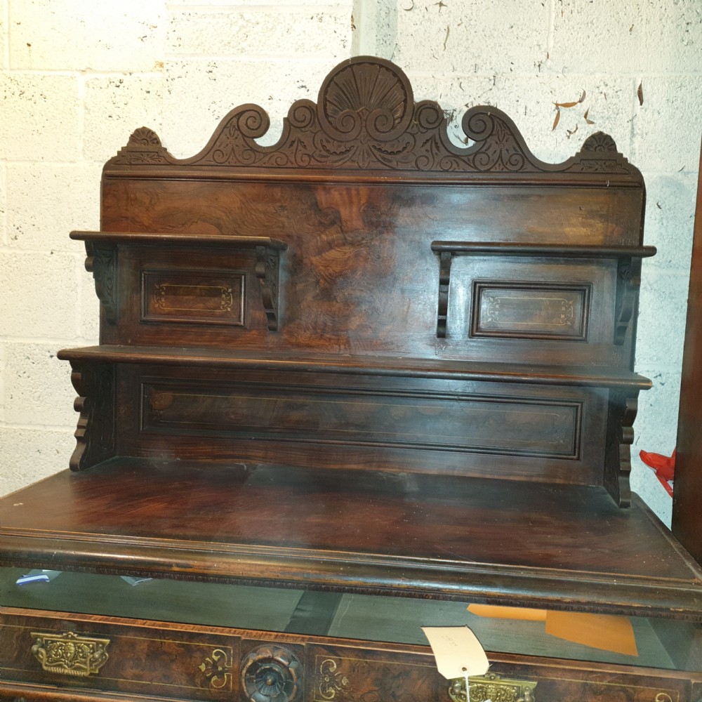 A dark brown Scottish Victorian dresser featuring a carved cresting rail, upper shelves, two drawers, and twin cupboard doors with a scumbled faux-grain finish. View VI