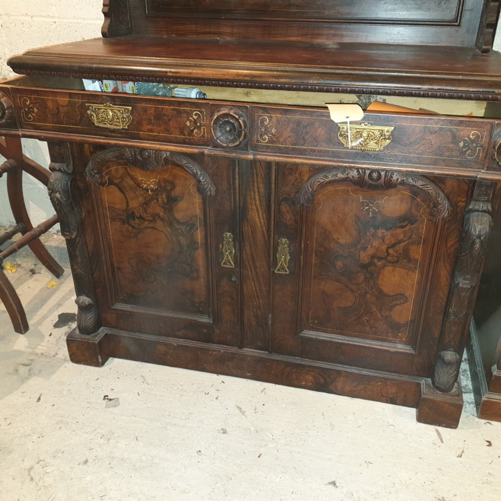 A dark brown Scottish Victorian dresser featuring a carved cresting rail, upper shelves, two drawers, and twin cupboard doors with a scumbled faux-grain finish. View VII