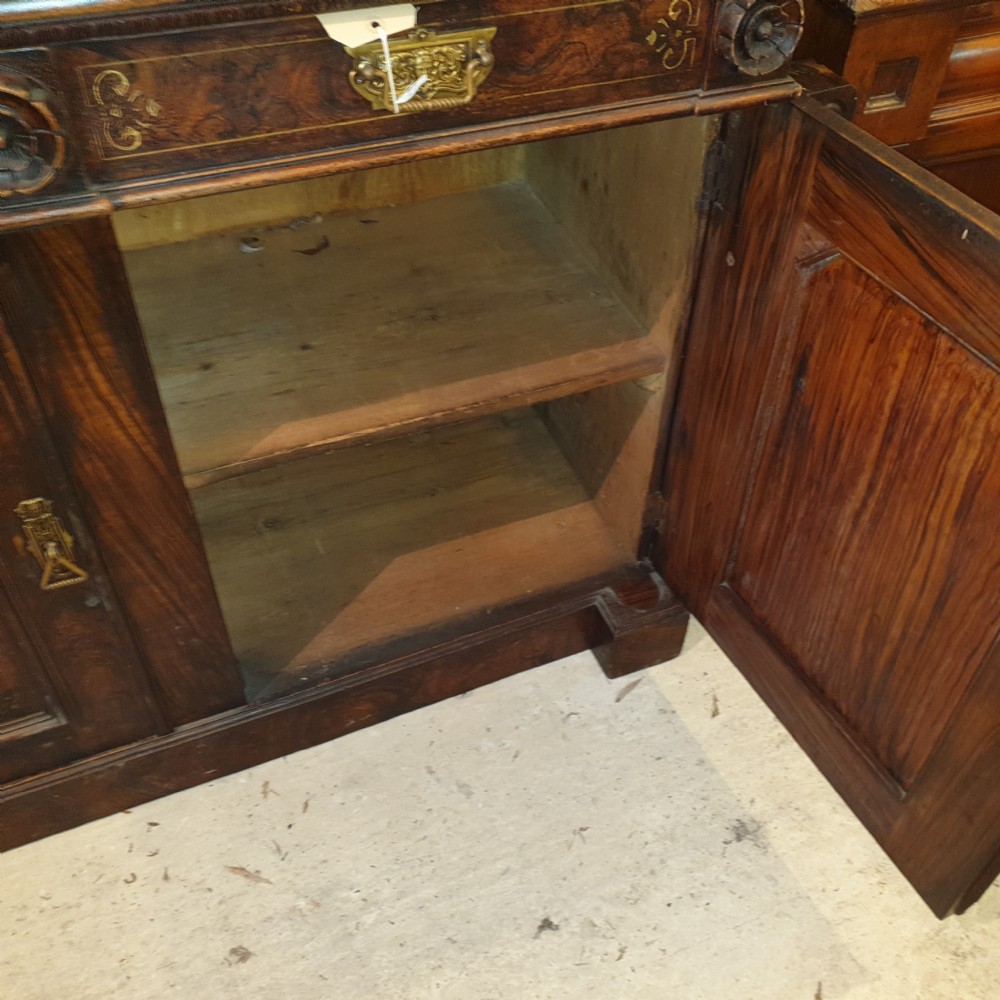 A dark brown Scottish Victorian dresser featuring a carved cresting rail, upper shelves, two drawers, and twin cupboard doors with a scumbled faux-grain finish. View VIII