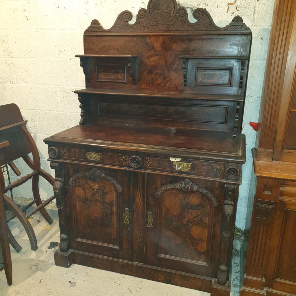 A dark brown Scottish Victorian dresser featuring a carved cresting rail, upper shelves, two drawers, and twin cupboard doors with a scumbled faux-grain finish. View IX