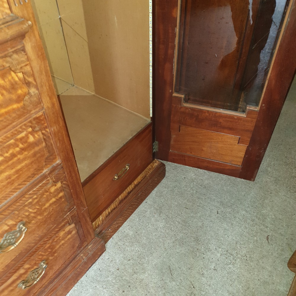 An Edwardian satinwood triple wardrobe featuring mirrored side doors, a central upper compartment, five drawers, and a stepped cornice top. View VI