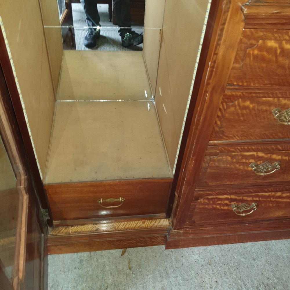 An Edwardian satinwood triple wardrobe featuring mirrored side doors, a central upper compartment, five drawers, and a stepped cornice top. View VII
