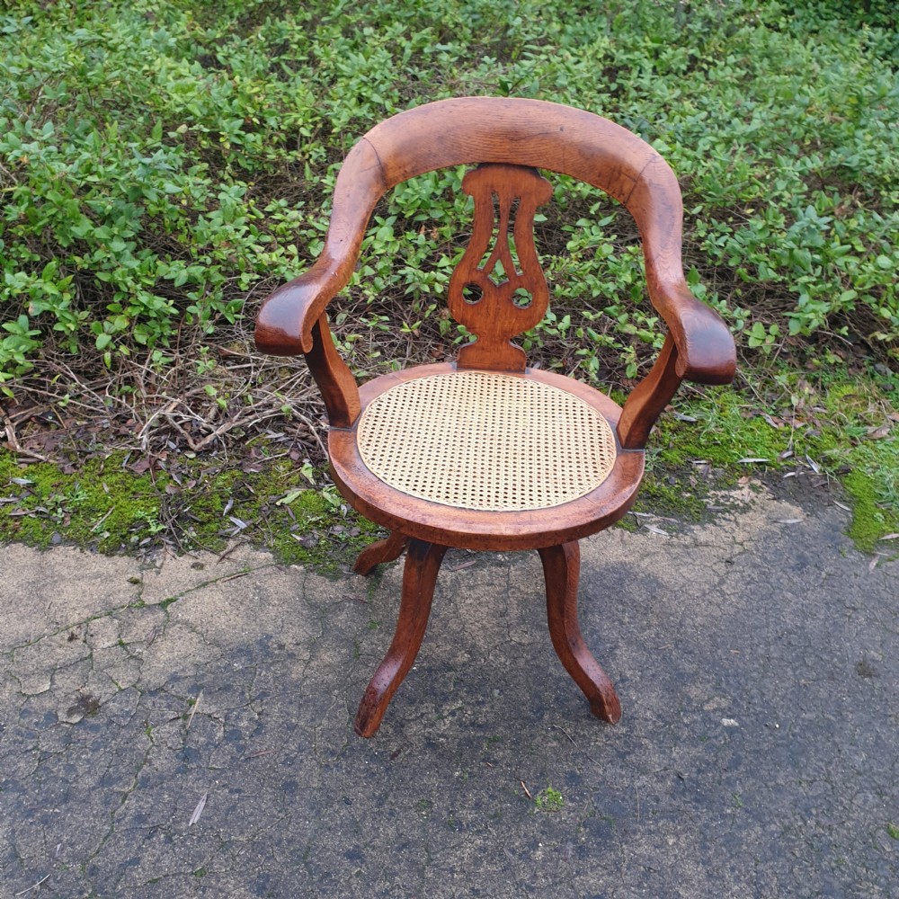Victorian oak cane seat revolving desk armchair 