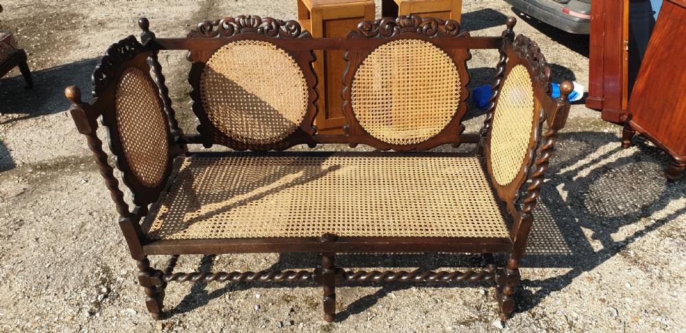 Carved oak and caned hall seat. 