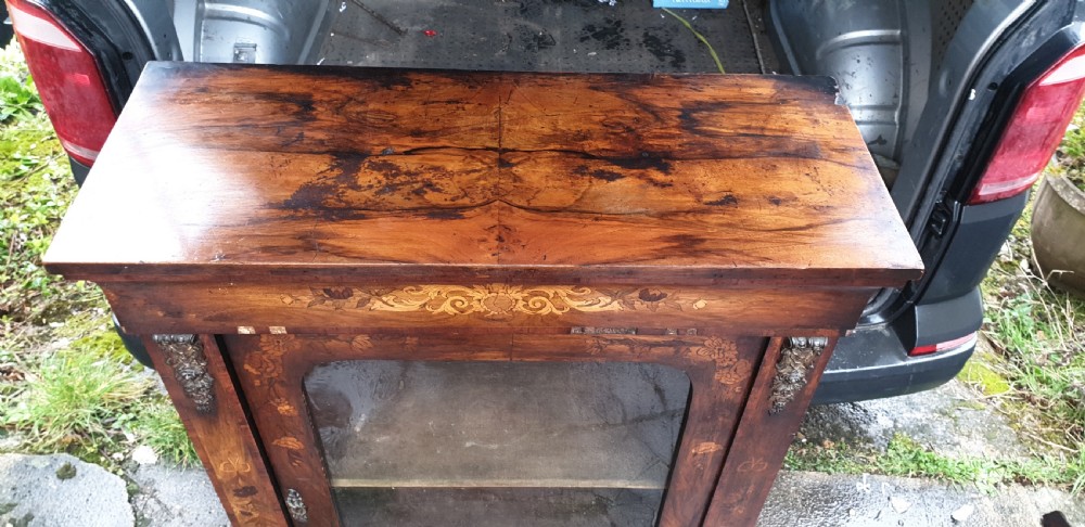 A Victorian walnut pier cabinet featuring floral marquetry inlay, a single glazed glass door, and gilt metal mounts on the side pilasters. View II