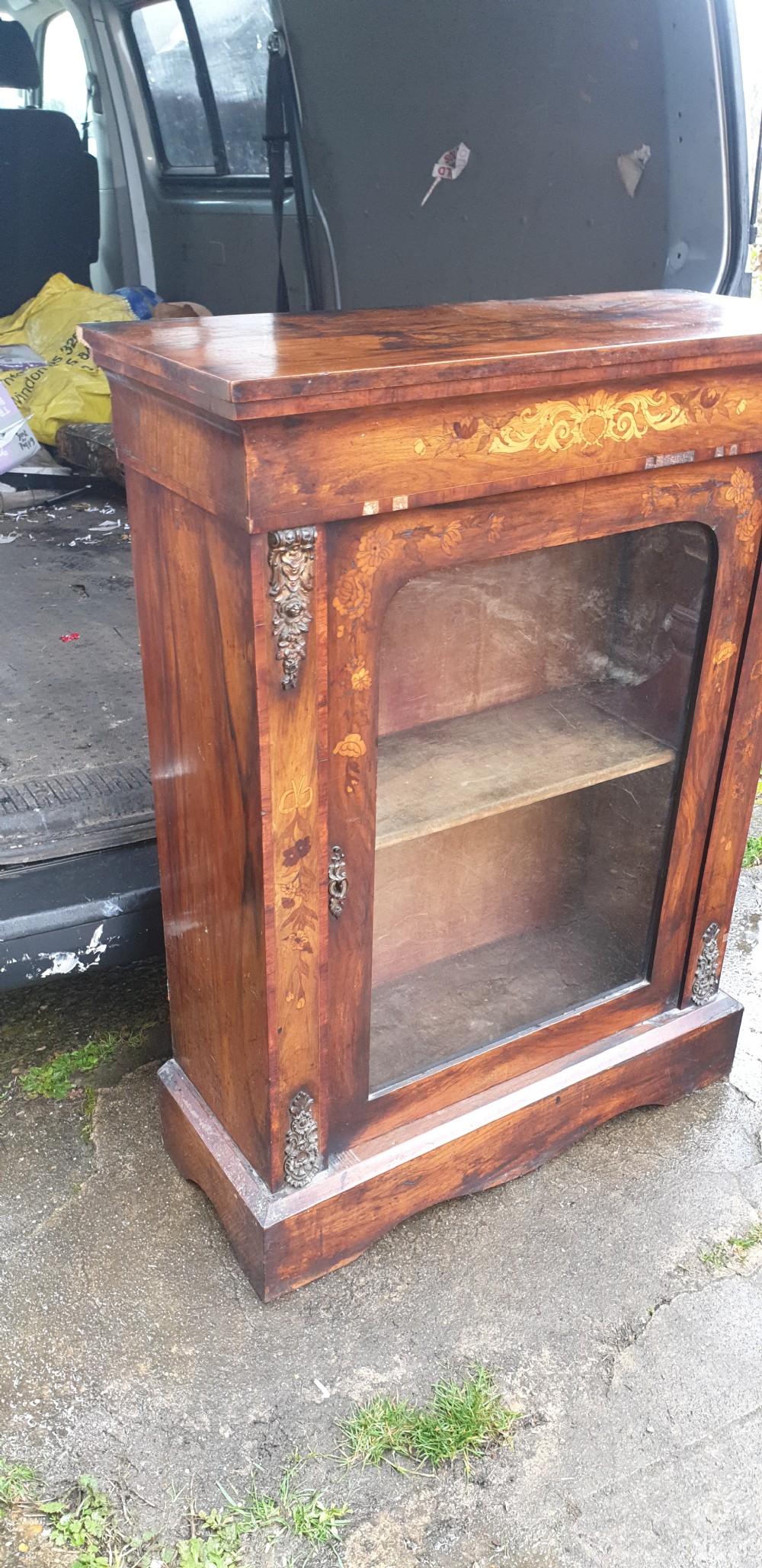 A Victorian walnut pier cabinet featuring floral marquetry inlay, a single glazed glass door, and gilt metal mounts on the side pilasters. View IV