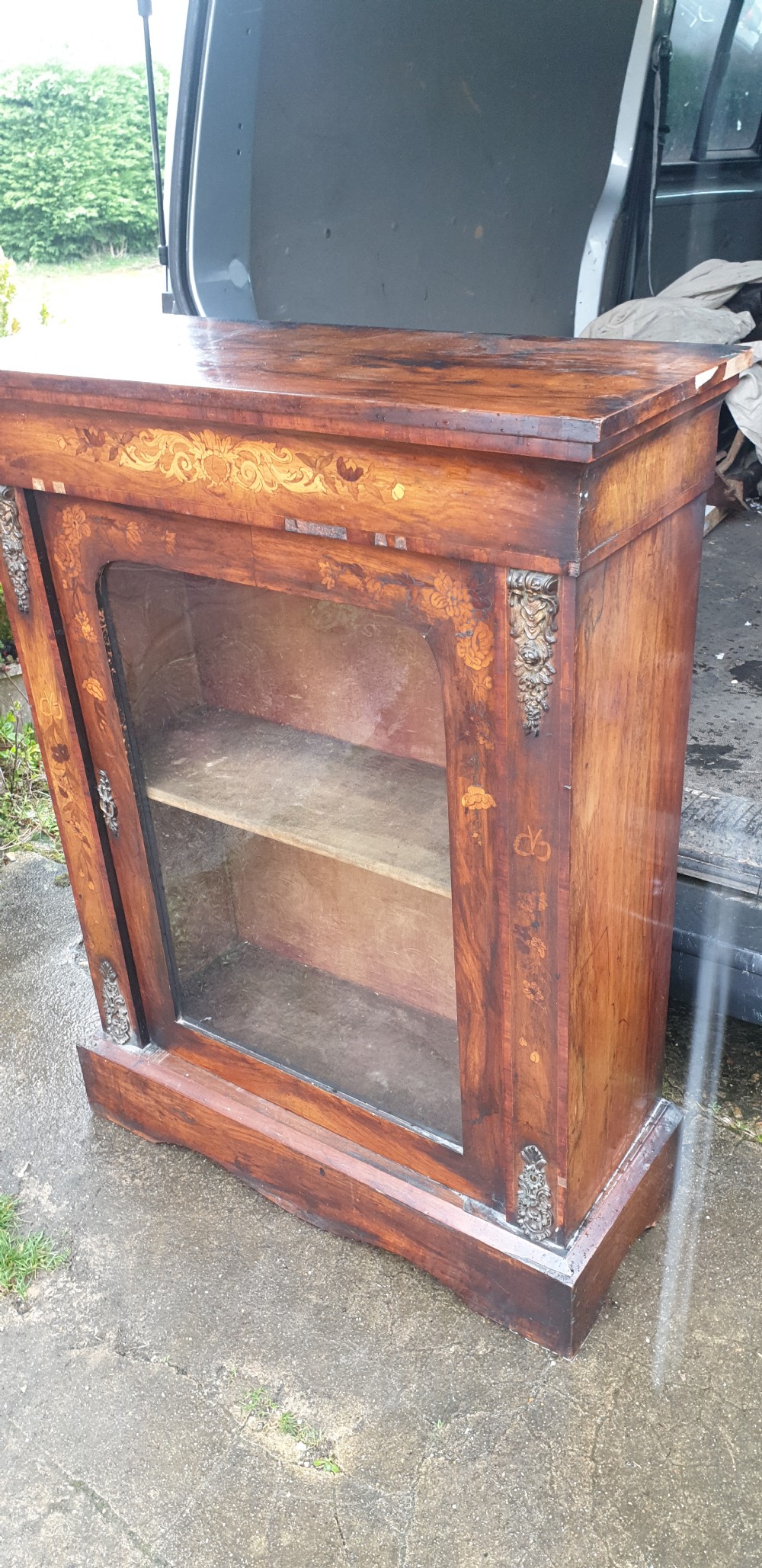 A Victorian walnut pier cabinet featuring floral marquetry inlay, a single glazed glass door, and gilt metal mounts on the side pilasters. View V