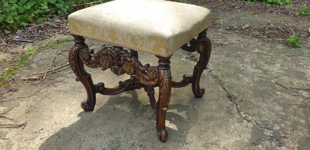 Carved walnut and gilt heightened stool.