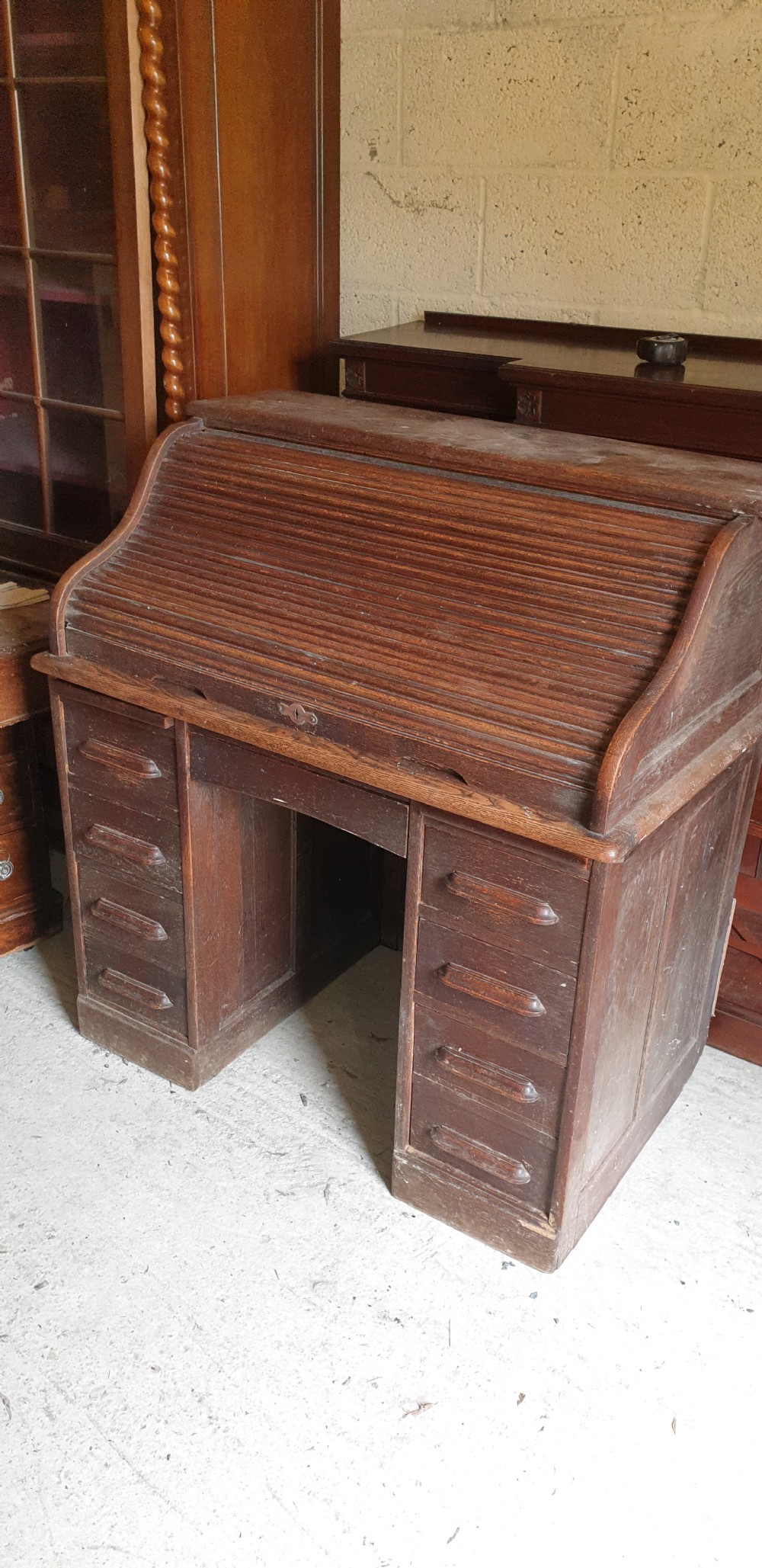 Small oak tambour roll top pedestal desk.