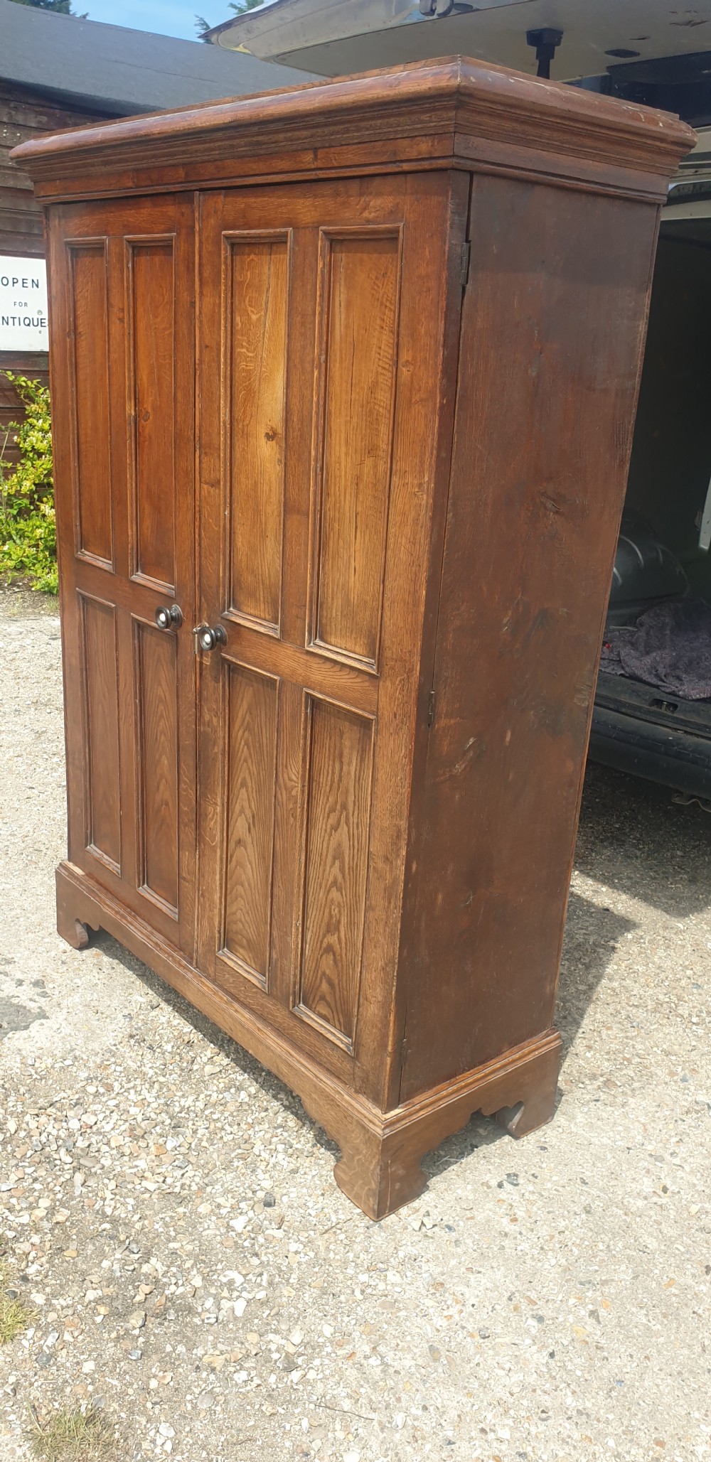 Useful early Victorian century panelled oak cupboard.  View II