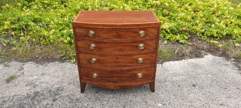 Regency inlaid bow front chest of 4l drawers.