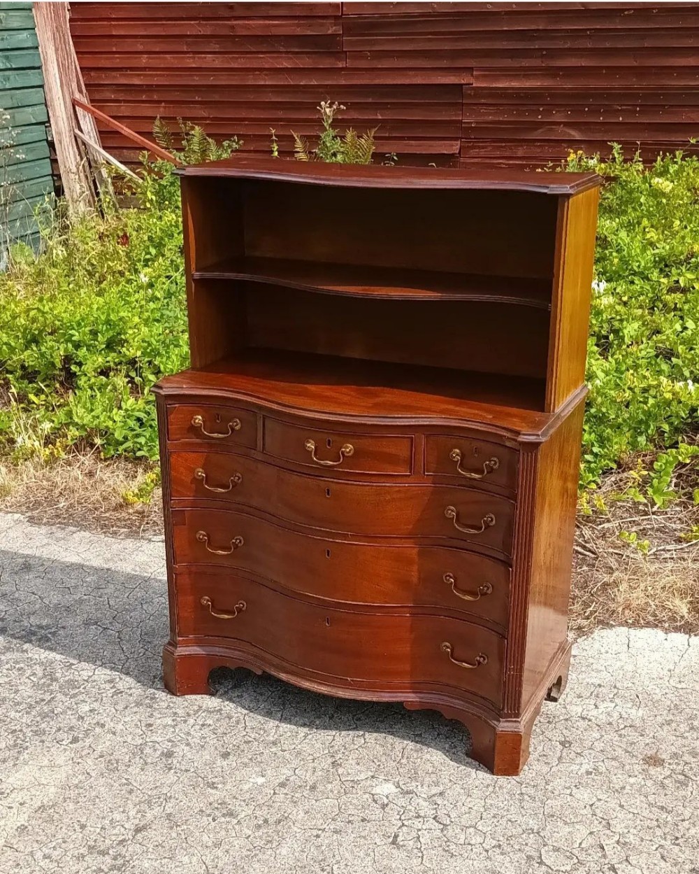 Compact mahogany chest of drawers with a bookcase.