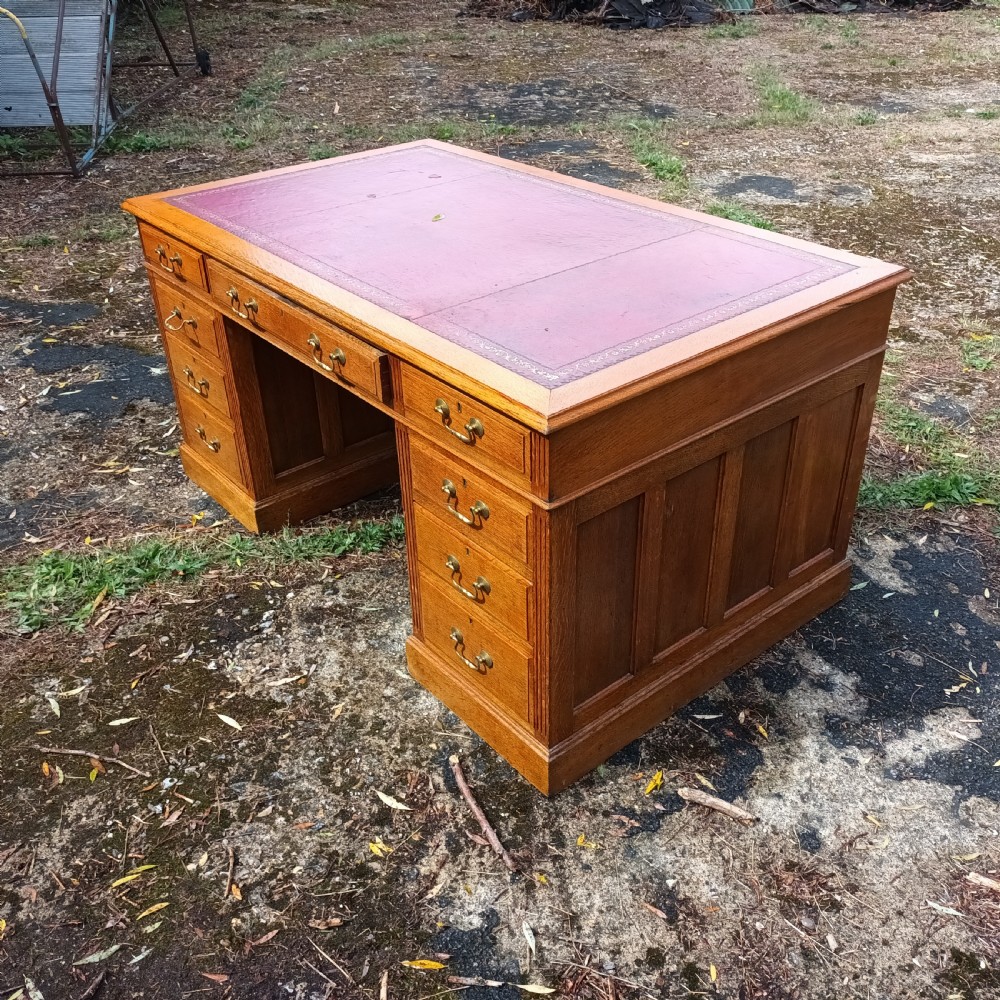 Early 20th century panelled oak kneehole pedestal desk.  View II