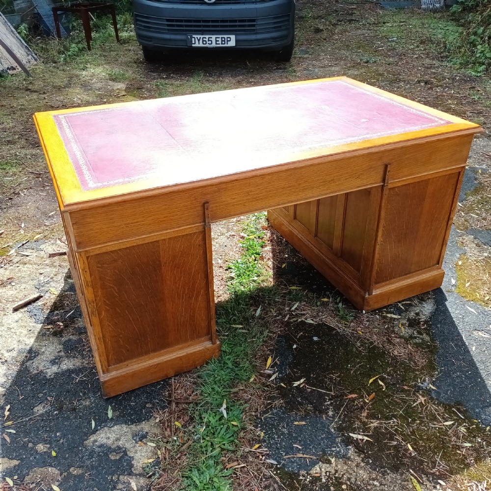 Early 20th century panelled oak kneehole pedestal desk.  View III