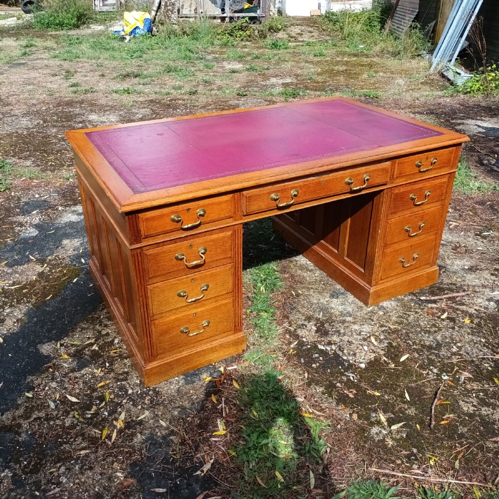 Early 20th century panelled oak kneehole pedestal desk.  View IV
