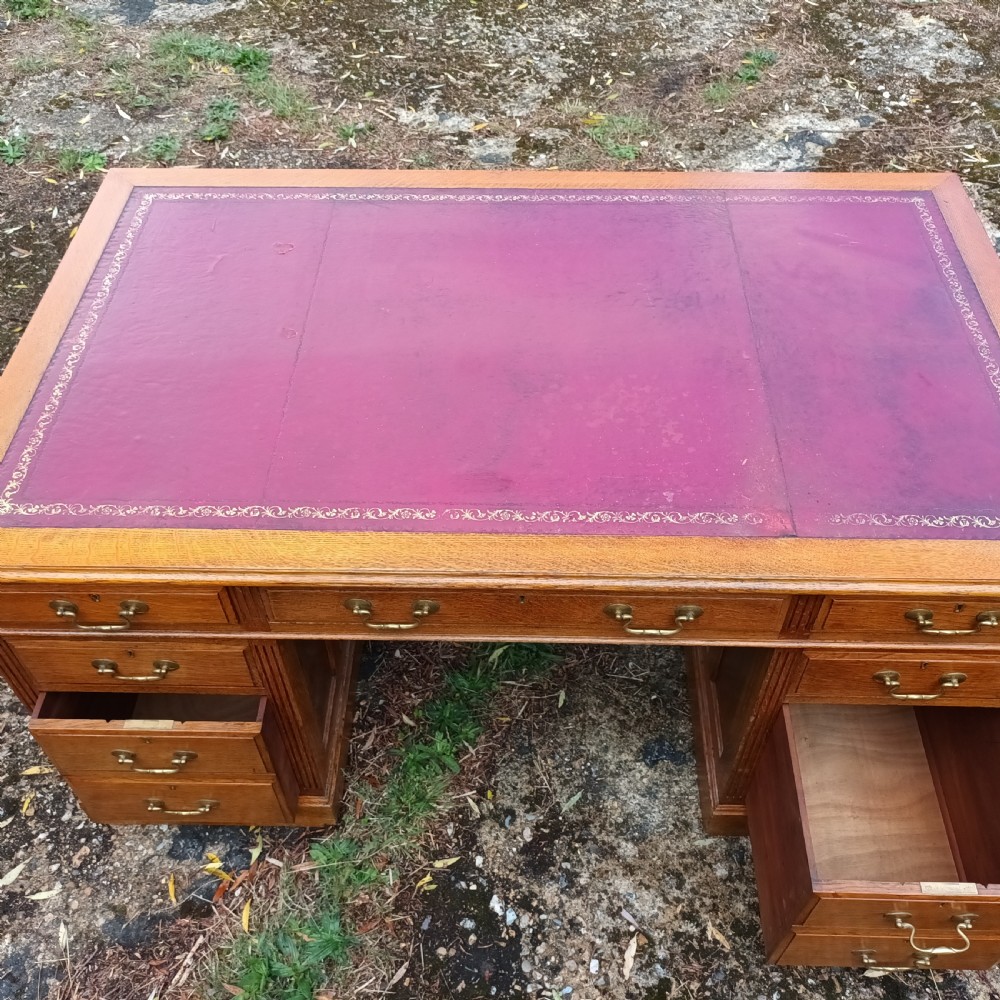 Early 20th century panelled oak kneehole pedestal desk.  View VI