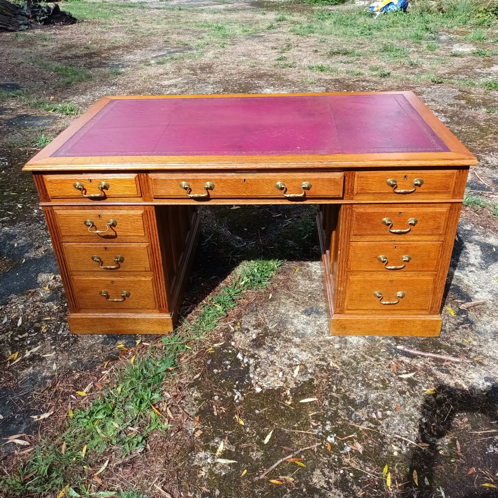 Early 20th century panelled oak kneehole pedestal desk.  View XII