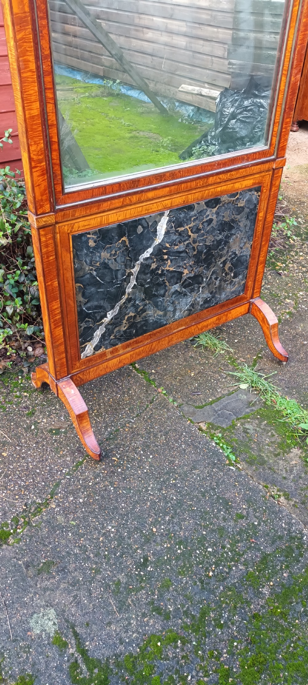 An early nineteenth-century timber cheval mirror featuring a shaped crest, slender side posts with finials, and a fold-down lower marble panel resting on splayed feet. View XII